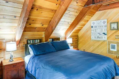 a bedroom with a blue bed in a wooden ceiling at Sequoia Forest Remote Retreat! Dreamtime Cabin in Ponderosa