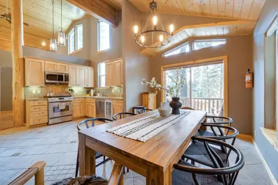 a kitchen with a wooden table and chairs at Tahoe Donner Mountain Cabin Surrounded by Forest! in Truckee