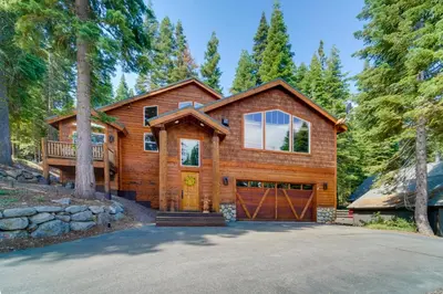 a log home with a garage at Tahoe Donner Mountain Cabin Surrounded by Forest! in Truckee