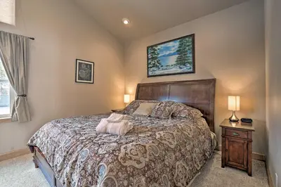 a bedroom with a large bed with a wooden headboard at 9 Mi to Heavenly Mountain South Lake Tahoe Home! in South Lake Tahoe