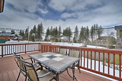 a wooden deck with a table and chairs on it at 9 Mi to Heavenly Mountain South Lake Tahoe Home! in South Lake Tahoe
