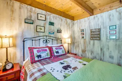a bedroom with a bed with a wooden wall at Private Mountain Retreat 8 Mi to Lake Tahoe! in South Lake Tahoe