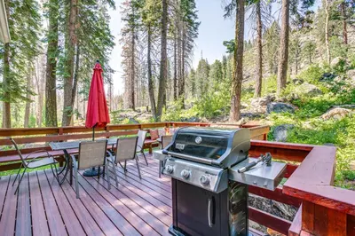 a deck with a grill and a table and chairs at Private Mountain Retreat 8 Mi to Lake Tahoe! in South Lake Tahoe