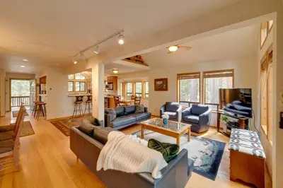 a living room with a couch and a tv at Truckee Home with Private Hot Tub on a Golf Course in Truckee