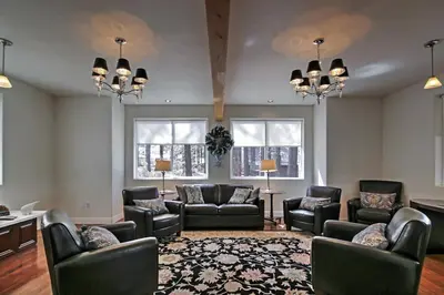 a living room with couches and chairs and windows at 1 Mi to Mtn, 1 More to Shore! Luxury Tahoe Home in South Lake Tahoe