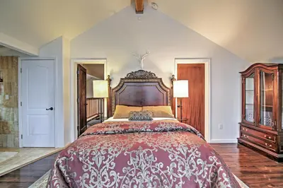 a large bedroom with a large bed with a wooden headboard at 1 Mi to Mtn, 1 More to Shore! Luxury Tahoe Home in South Lake Tahoe