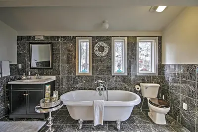 a bathroom with a tub and a toilet and a sink at 1 Mi to Mtn, 1 More to Shore! Luxury Tahoe Home in South Lake Tahoe