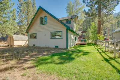 a house with a yard with a fence at 11 Mi to Ski Resorts! Lake Tahoe Gem with Pool Table in South Lake Tahoe