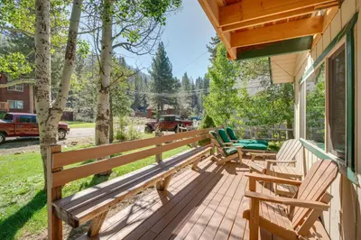 a porch with two wooden benches on a house at 11 Mi to Ski Resorts! Lake Tahoe Gem with Pool Table in South Lake Tahoe