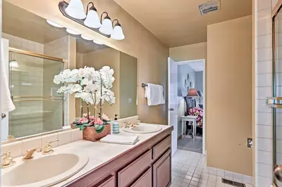 a bathroom with two sinks and a large mirror at 1 Mi to Shore Quiet South Lake Tahoe Condo in South Lake Tahoe