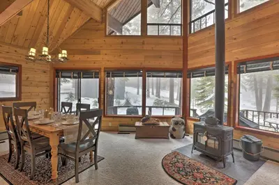 a dining room with a table and a wood stove at 2 Mi to Northstar Resort Idyllic Cabin with Shuttle in Truckee