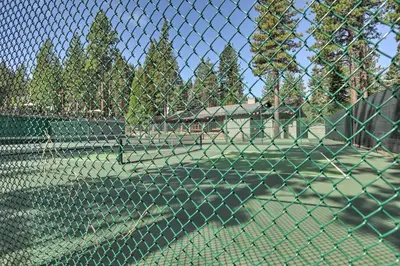 a chain link fence on a tennis court at 2 Mi to Northstar Resort Idyllic Cabin with Shuttle in Truckee