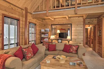 a living room with a couch and a table at 2 Mi to Northstar Resort Idyllic Cabin with Shuttle in Truckee