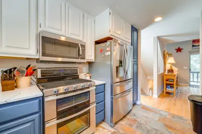 a kitchen with white cabinets and stainless steel appliances at Incline Village Retreat Near Skiing and Beaches in Incline Village