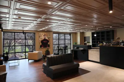 a living room with a coffered ceiling and a bar at The Hotel at Black Oak Casino Resort in Tuolumne