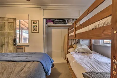 a bedroom with two beds and a bunk bed at Creekside Cabin 8 Mi to Kings Canyon National Park in Miramonte