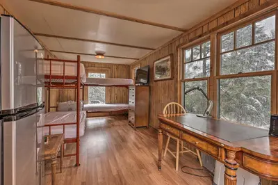 a bedroom with bunk beds and a desk in a room at Creekside Cabin 8 Mi to Kings Canyon National Park in Miramonte