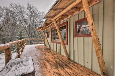a covered porch of a house in the snow at Creekside Cabin 8 Mi to Kings Canyon National Park in Miramonte