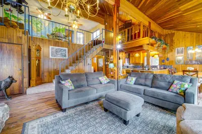 a living room with two couches and a staircase at Waterfront Truckee Cabin on Donner Lake! in Truckee