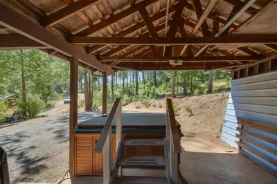 a porch of a house with a hot tub at 6 Mi to Yosemite Natl Park 14-Acre Retreat! in Groveland