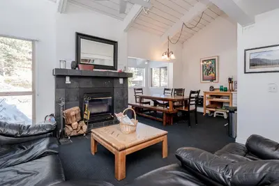 a living room with leather furniture and a fireplace at Chamonix # 62 in Mammoth Lakes