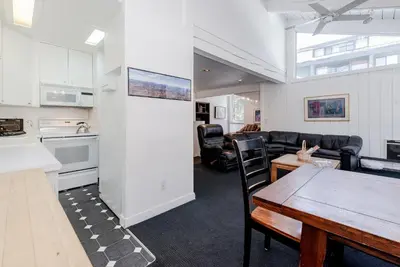 a kitchen and a living room with a table and chairs at Chamonix # 62 in Mammoth Lakes