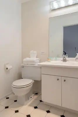 a white bathroom with a toilet and a sink at Chamonix # 62 in Mammoth Lakes