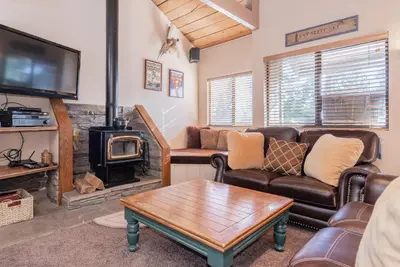 a living room with a couch and a wood stove at Bigwood W #90 in Mammoth Lakes