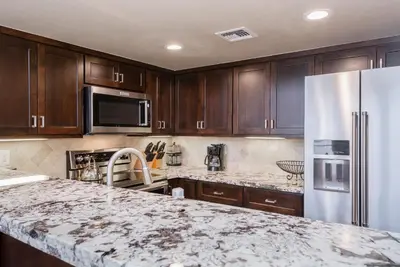 a kitchen with wooden cabinets and a white refrigerator at Snowcreek #856 Phase V in Mammoth Lakes