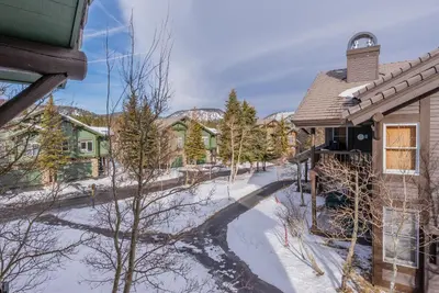 a snowy street in a town with houses at Snowcreek #856 Phase V in Mammoth Lakes