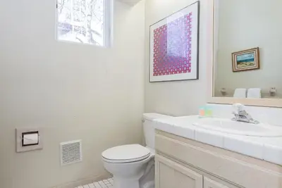 a white bathroom with a toilet and a sink at Snowcreek - #510 Phase IV in Mammoth Lakes