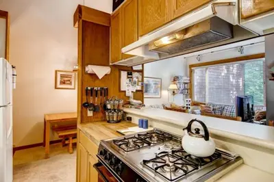 a kitchen with a stove with a tea kettle on it at Ski-InandSki-Out Northstar Condo Near Lake Tahoe! in Truckee
