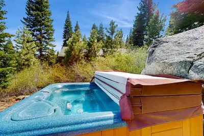 a jacuzzi tub in a field with a rock at Extraordinary Tahoe-Donner Modern Mountain Home in Truckee