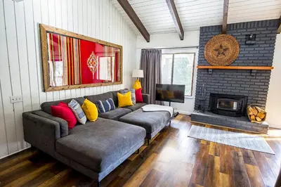 a living room with a couch and a fireplace at The Mammoth House in Mammoth Lakes