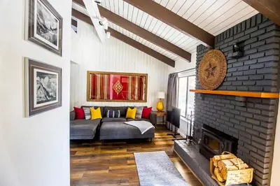 a living room with a couch and a fireplace at The Mammoth House in Mammoth Lakes