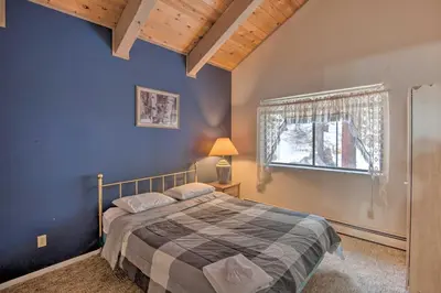 a bedroom with a large bed and a window at Stateline Ski House Walk to Boulder Lift! in Stateline