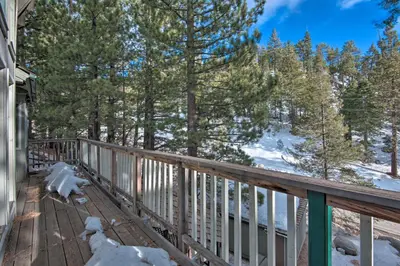 a deck with a view of the snow covered trees at Stateline Ski House Walk to Boulder Lift! in Stateline