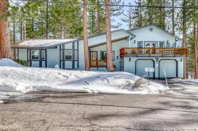 a house in the woods with snow on the ground at Skyline Serenity in South Lake Tahoe