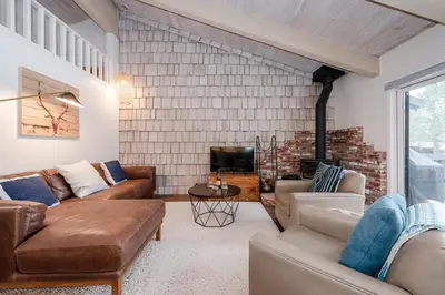 a living room with couches and a fireplace at Chateau Blanc 11 in Mammoth Lakes