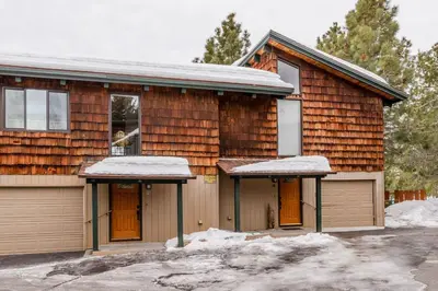 a wooden house with snow on the roofs at Chateau Blanc 11 in Mammoth Lakes