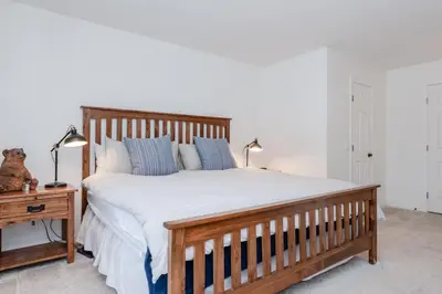 a bedroom with a large wooden bed with blue pillows at Chateau Blanc 11 in Mammoth Lakes