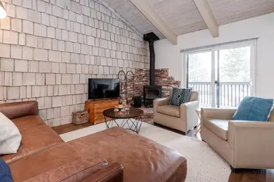 a living room with a couch and chairs and a tv at Chateau Blanc 11 in Mammoth Lakes
