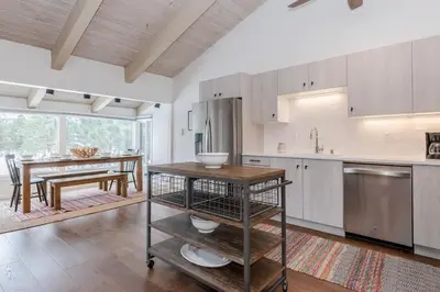 a kitchen with a table and a dining room at Chateau Blanc 11 in Mammoth Lakes