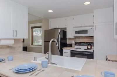 a kitchen with white cabinets and a counter top at Snowcreek I 33 in Mammoth Lakes