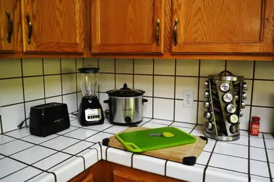 a kitchen counter with a cutting board and a blender at Blue Jay Paradise in Three Rivers