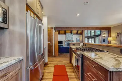 a large kitchen with stainless steel appliances and wooden cabinets at Country Club Retreat in South Lake Tahoe