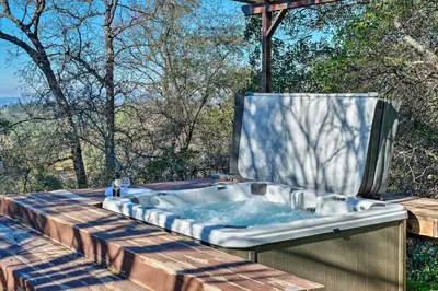 a hot tub sitting on a wooden deck at Hot Tub and Mtn Views Peaceful Columbia Retreat! in Columbia