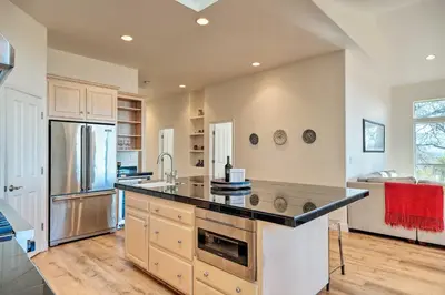 a kitchen with a counter top and a refrigerator at Hot Tub and Mtn Views Peaceful Columbia Retreat! in Columbia
