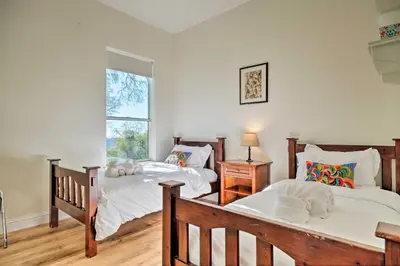a bedroom with two beds and a window at Hot Tub and Mtn Views Peaceful Columbia Retreat! in Columbia