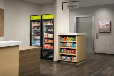 a store with two refrigerators and a aisle with drinks at Home2 Suites By Hilton Clovis Fresno Airport in Clovis